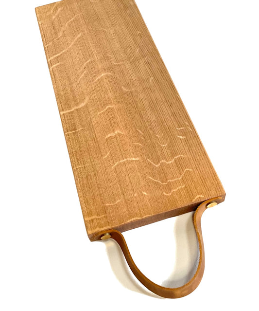Long oak chopping / tapas board with leather strap.