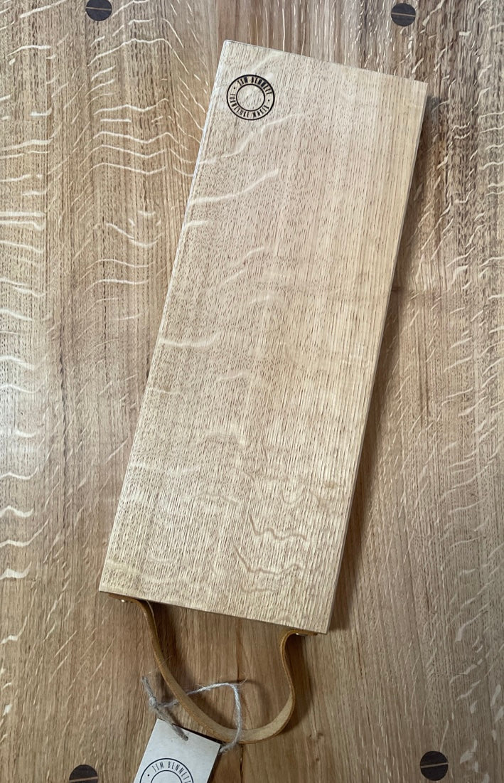 Long oak chopping / tapas board with leather strap.